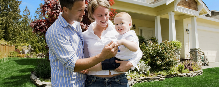 Young Family in front of new home