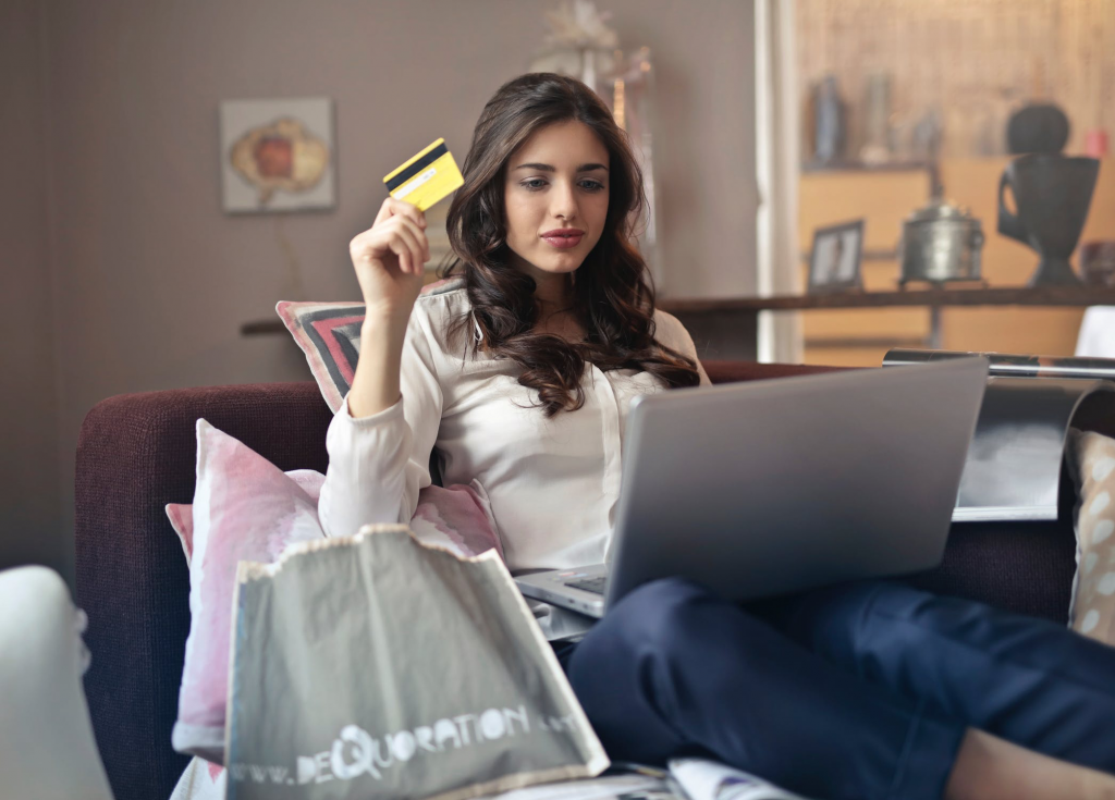 Teen Using Debit Card on Computer